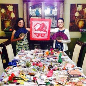 Two sisters show off their haul of souvenirs from an international convention