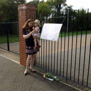 Victoria Summers leaves a memorial at her local kingdom hall, accompanied by her daughter Holly